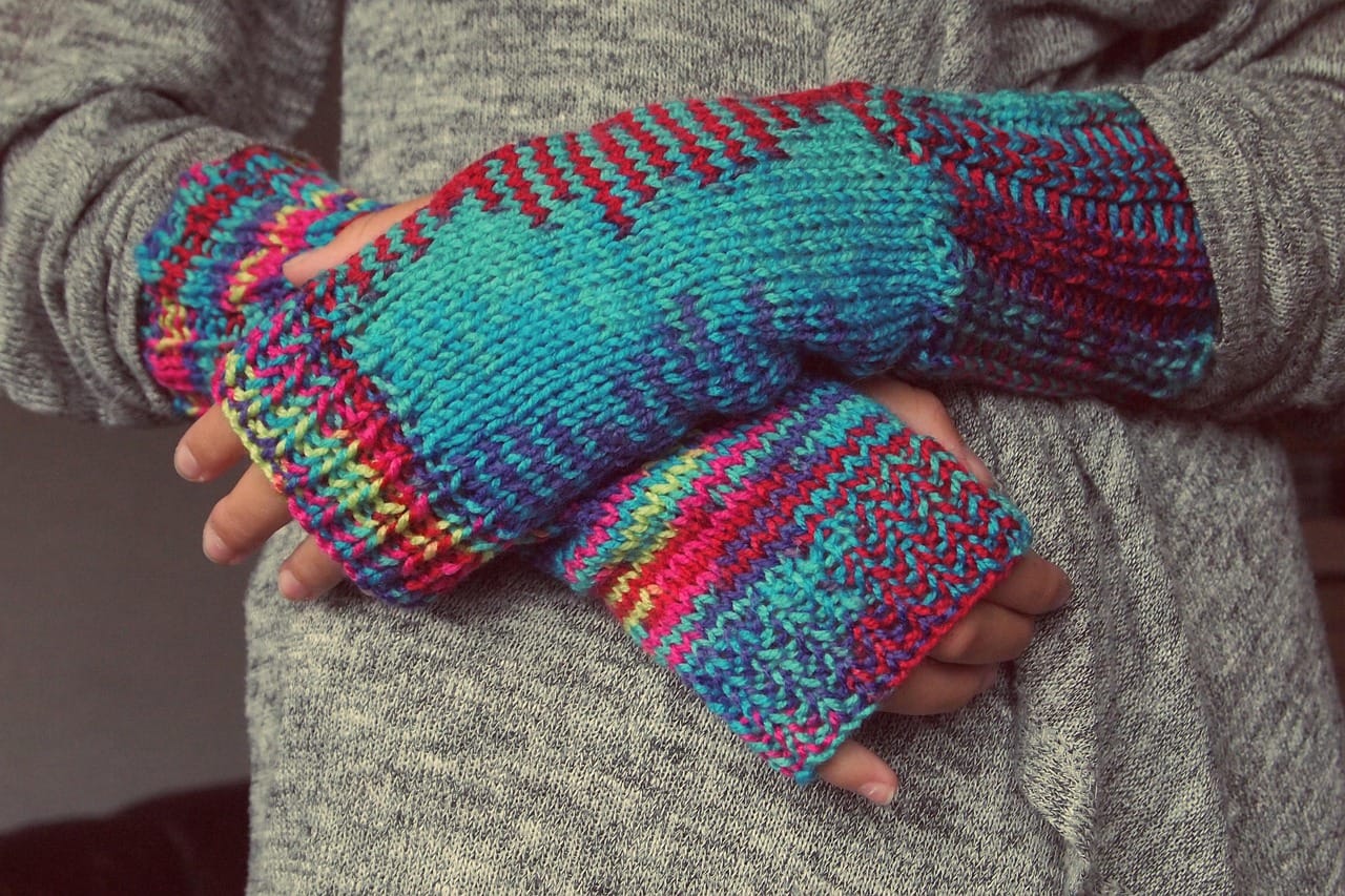 Two layers: thin gloves for buttons, warm mittens over the top.
