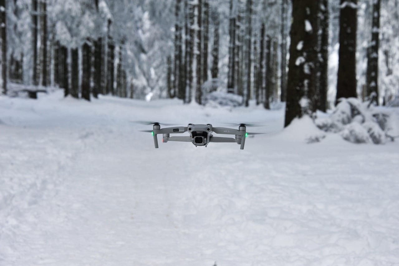 Taking off from a cleared patch of snow. The drone needs a flat, dry surface to land on.